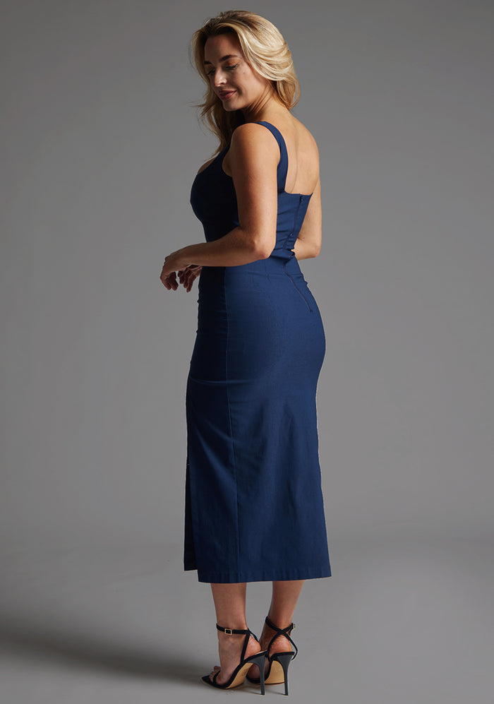 Side back image of a model in the Vesper Abbie Square Neck Midaxi Dress in Navy, revealing the side back sleek profile and structured design.