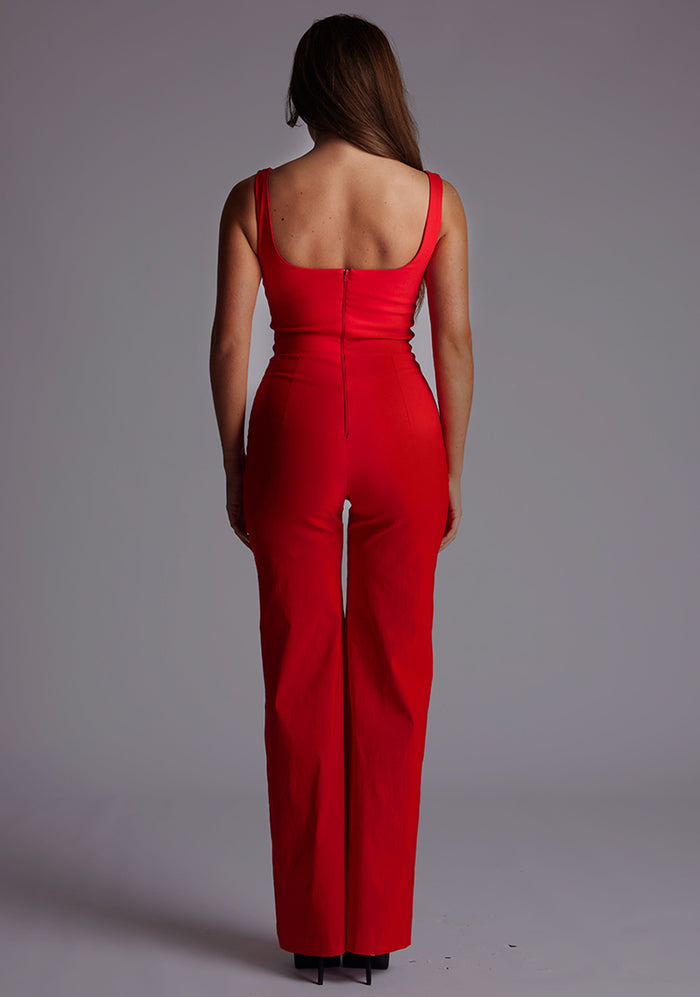 Back image of a model wearing the Vesper Alana Square Neck Wide Leg Jumpsuit in Red, showcasing the clean back design and elegant wide leg.