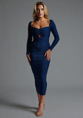 Front image of a model wearing the Vesper Amy Sweetheart Neckline Long Sleeve Midaxi Dress in Navy, featuring a sculpted sweetheart neckline, subtle front cutout, and sleek midaxi silhouette, pose against a grey studio backdrop.