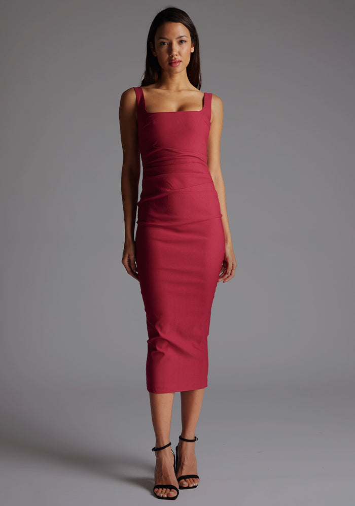 Front image of a model wearing the Vesper Andy Square Neck Midaxi Dress in Raspberry, featuring a clean square neckline and sculpting bodycon silhouette, posed against a grey studio backdrop.