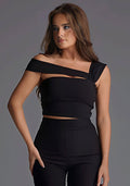 Close-up image of a model wearing the Vesper Angel Asymmetric Neckline Top in Black, focusing on the sculpted one-shoulder cut and refined finish.