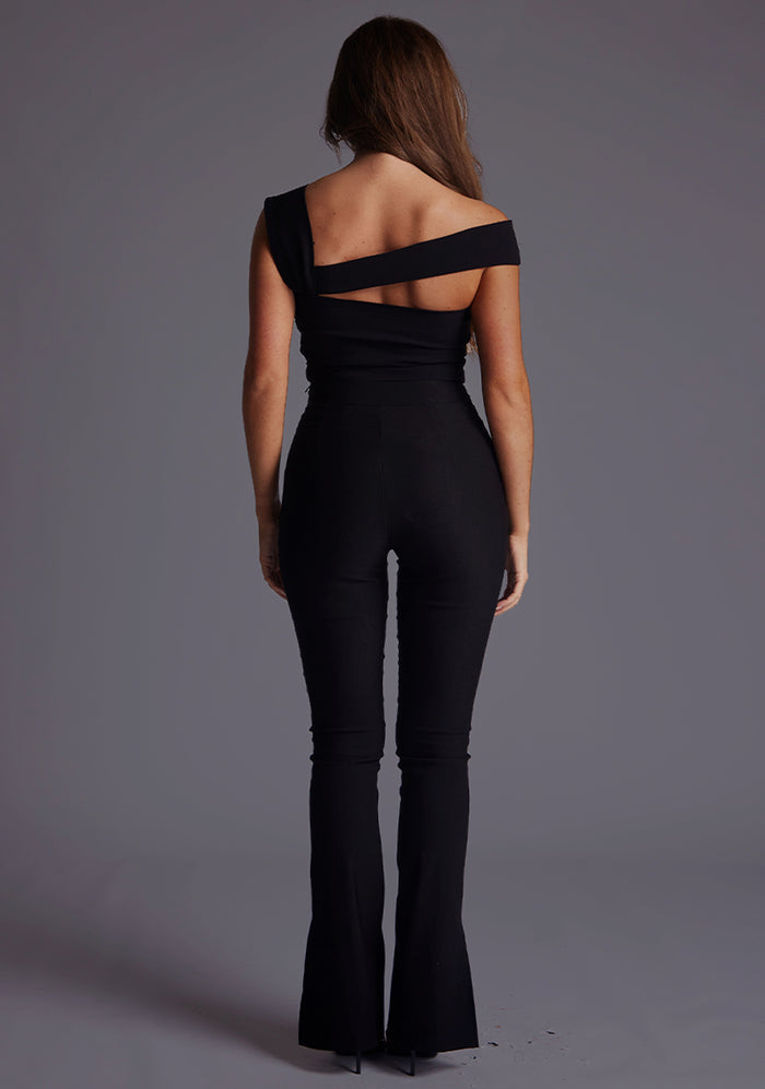 Back image of a model wearing the Vesper Angel Asymmetric Neckline Top in Black, displaying a clean, minimal back design with a smooth, sculpted silhouette.