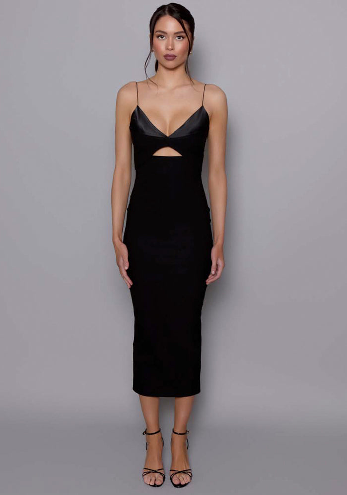 Front image of a model wearing the VSPR Angelina Strappy Cut Out Midaxi Dress in Black featuring a plunging satin bust, front cut-out, and thin shoulder straps, posed against a neutral grey studio backdrop.