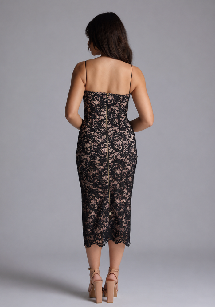 Woman wearing the Vesper Petite Arden black lace bodycon midaxi dress against a grey background, back view