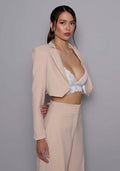 Close-up side-front view of the VSPR Aria cropped stone jacket, highlighting the sharp tailoring, defined waist, and structured shoulder details for a modern, powerful look.