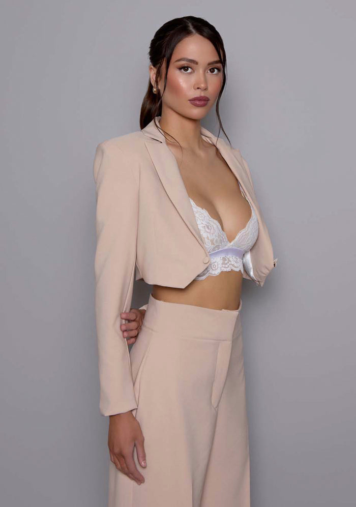 Close-up side-front view of the VSPR Aria cropped stone jacket, highlighting the sharp tailoring, defined waist, and structured shoulder details for a modern, powerful look.