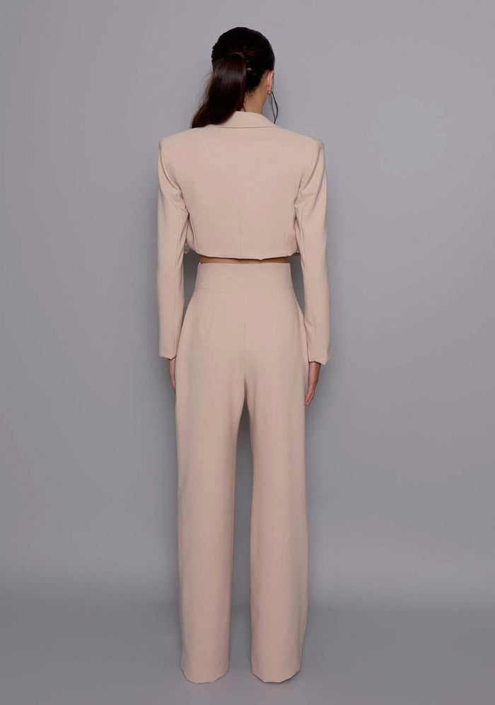 Back view of the VSPR Aria Jacket in Stone with a structured fit and clean seams, emphasizing its flawless tailoring and cropped cut from behind.