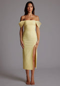 Front image of a model wearing a yellow Bardot midaxi dress with a stunning Bardot neckline, with armbands and a front skirt split. The design featured is the VSPR Astra Yellow Bardot Midaxi Dress.