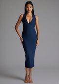 Front image of a model wearing the Vesper Aubrey Plunge Midaxi Dress in Navy featuring a deep V-neckline, sleeveless cut, and sleek bodycon silhouette, against a grey studio backdrop.