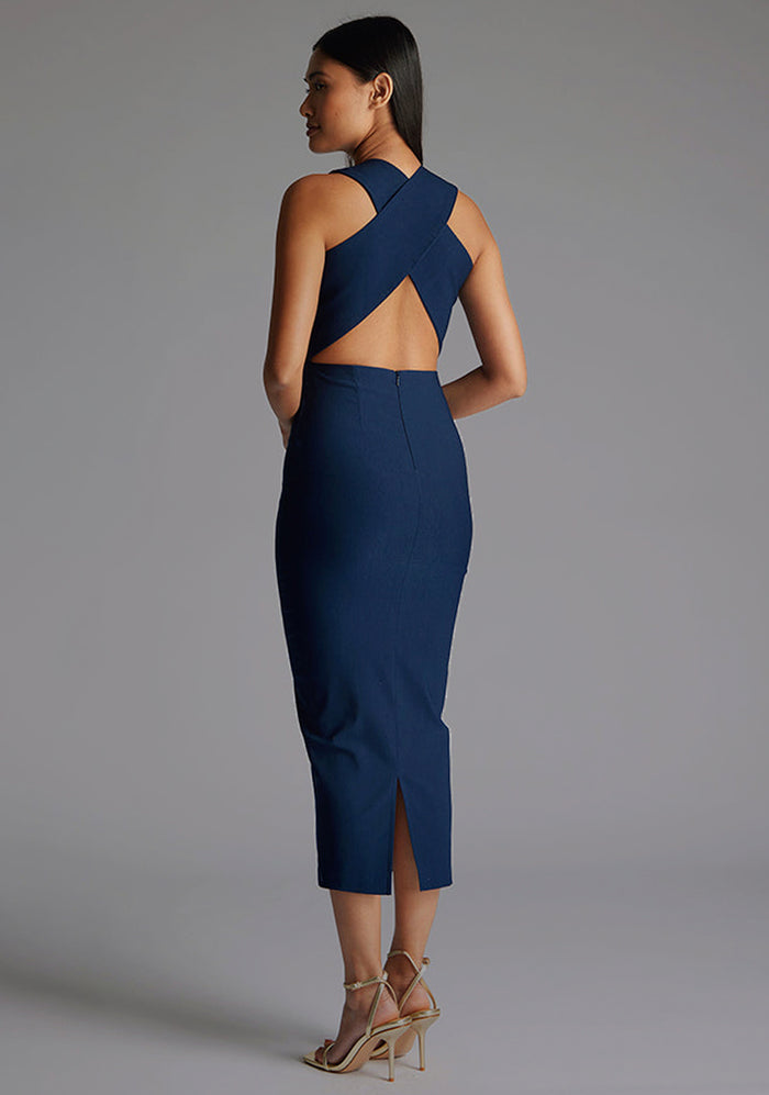 Side back image of a model wearing the Vesper Aubrey Plunge Midaxi Dress in Navy highlighting crisscross strap,  refined bodycon cut and polished navy finish.