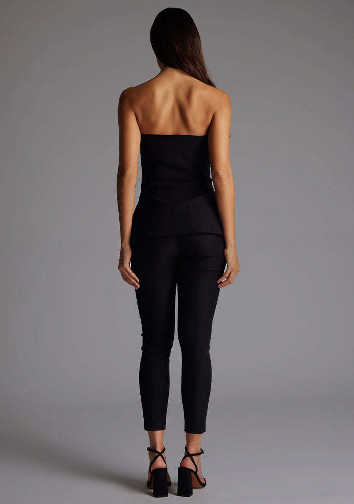 Back image of a model wearing the Vesper Augusta Bandeau Longline Top in Black, featuring a clean strapless back and elegant longline silhouette.
