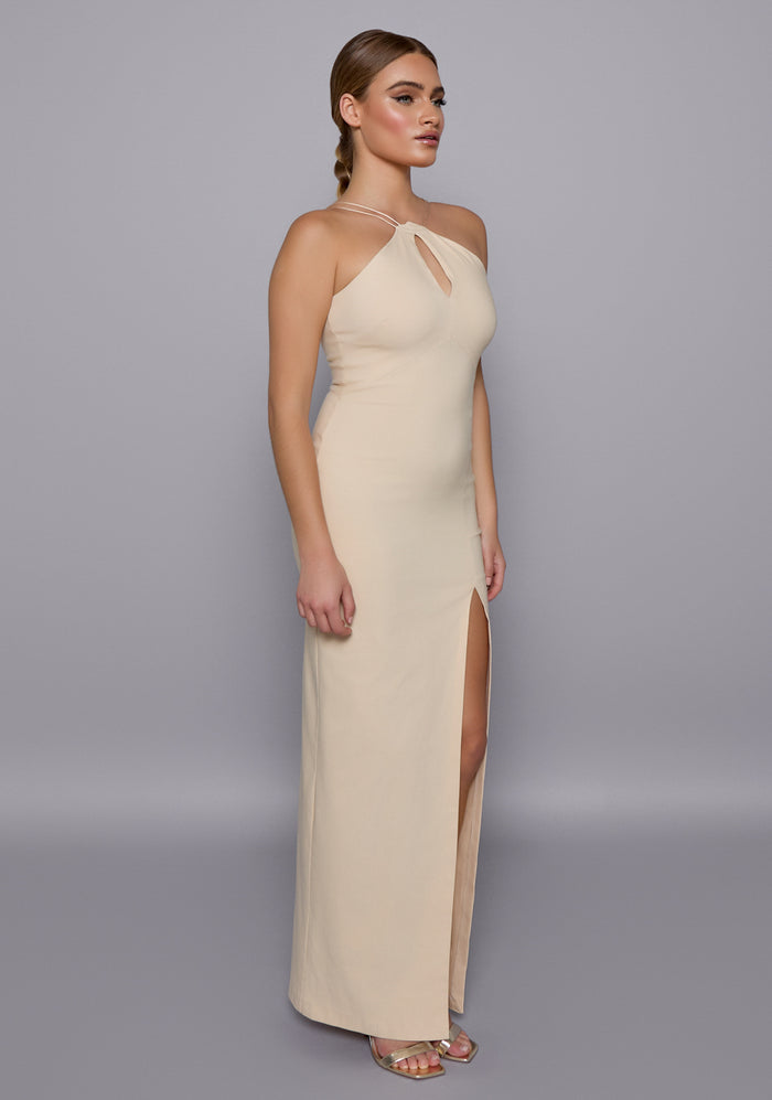 Side-front view of the VSPR Auralia Stone Maxi Dress highlighting the slim fit, double-thin shoulder straps, and elegant front skirt split, revealing a softly contoured silhouette.