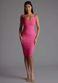 Front image of a model wearing the Vesper Azzura Bodycon Midi Dress in Pink with a soft V-neckline and curve-hugging silhouette, standing against a grey studio backdrop.
