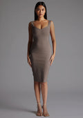 Front image of a model wearing the Vesper Azzura Bodycon Midi Dress in Taupe with a soft V-neckline and elegant bodycon silhouette, standing against a grey studio backdrop.