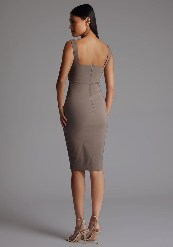 Side back image of a model wearing the Vesper Azzura Bodycon Midi Dress in Taupe, highlighting the elegant bodycon shape and midi-length.