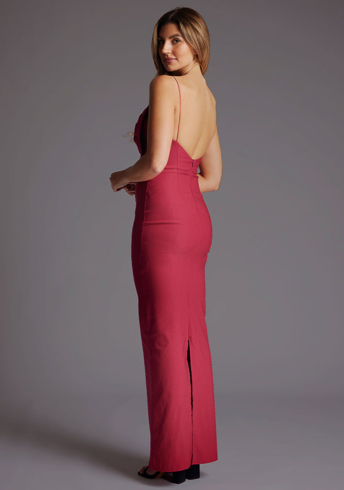 Side back image of a model wearing the Vesper Bellini Cami Strap Bow Maxi Dress in Raspberry, revealing the delicate strap placement and smooth flowing back silhouette.