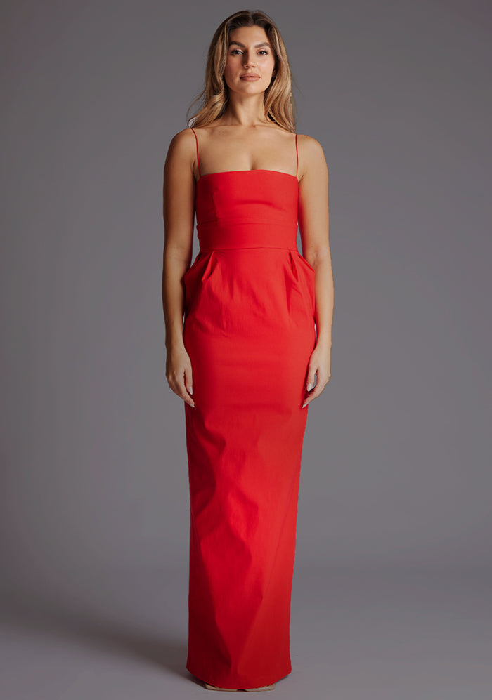 Front image of a model wearing a red square neck maxi dress with a chic straight neckline, delicate thin straps and sleek slim fit. The design featured is the Vesper Bergen Maxi Dress