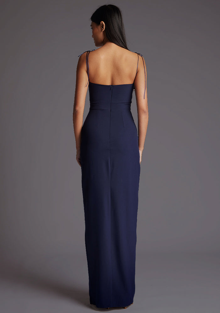 Back image of a model wearing the Vesper Bronte Tie Strap Maxi Dress in Navy, showcasing the clean back design, elegant strap detailing, and refined fit.