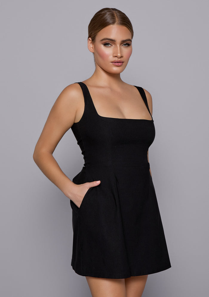 Close-up side-front angle of the VSPR Camille Dress highlighting the sculpted bodice, square neckline, and soft structure of the flared mini skirt.