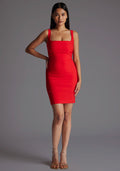 Front image of a model wearing the Vesper Carly Square Neck Mini Dress in Red, featuring a bold square neckline and figure-sculpting fit, standing against a grey studio backdrop.