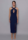 Model wearing the VSPR Carter navy midaxi dress featuring a halterneck twist neckline and plunging front cut-out, styled against a neutral studio backdrop.
