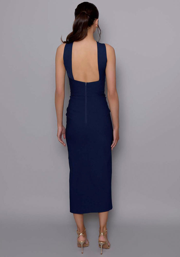 Back view of the VSPR Carter dress with squared open-back and clean seam detailing, revealing the sleek silhouette and midaxi length.