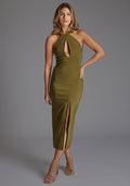 Front image of a model wearing the Vesper Carter Halterneck Bodycon Midaxi Dress in olive featuring a halter-twist neckline, front cut-out, front skirt split and sleek midaxi silhouette, standing against a grey studio backdrop.