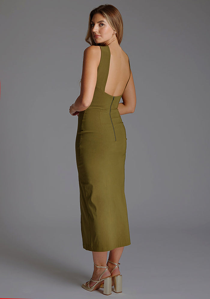 Side back image of a model wearing the Vesper Carter Halterneck Bodycon Midaxi Dress in Olive, revealing the sleek back profile and smooth finish.