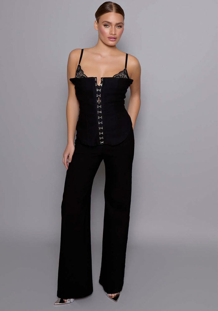 Model wearing the VSPR Cassia sculpted Basque in Black with a hook-and-eye front closure, contoured bodice seams, and adjustable straps, against a minimalist gray studio backdrop.
