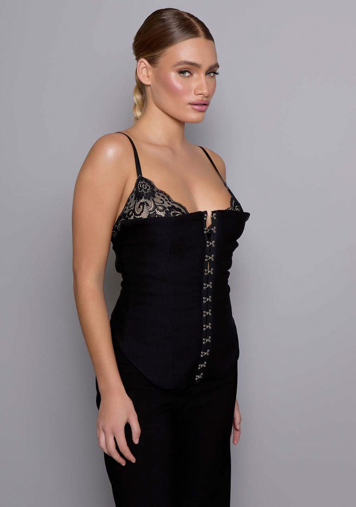 Close-up side of the VSPR Cassia basque from the side and front, highlighting the structured fabric, soft squared neckline, and lace-trimmed edges that define the romantic yet sleek design.