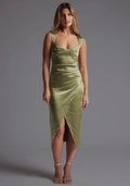 Front image of a model wearing olive satin midaxi dress with  a sweetheart neckline, wide comfy straps and front skirt split. The dress featured is the Vesper Desiree Olive Satin Midaxi Dress.