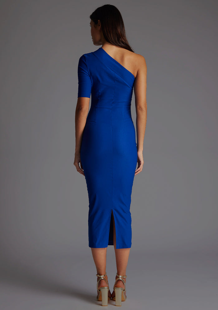 Back image of model wearing a cobalt midaxi dress with a eye-catching asymmetric design with a stunning one-sleeve detail and slim fit enhances your curves and creates a flattering silhouette. The design featured is the Vesper Erin Cobalt Midaxi Dress