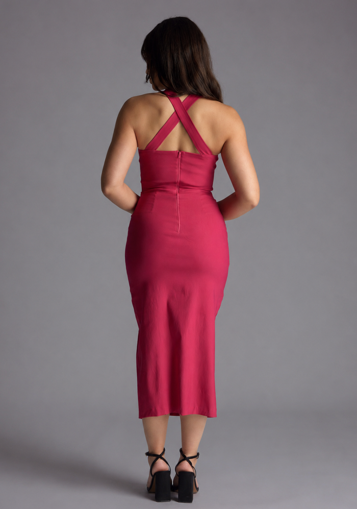 Woman wearing the Vesper Petite Nellie cerise notch neck midaxi dress against a grey background, back view